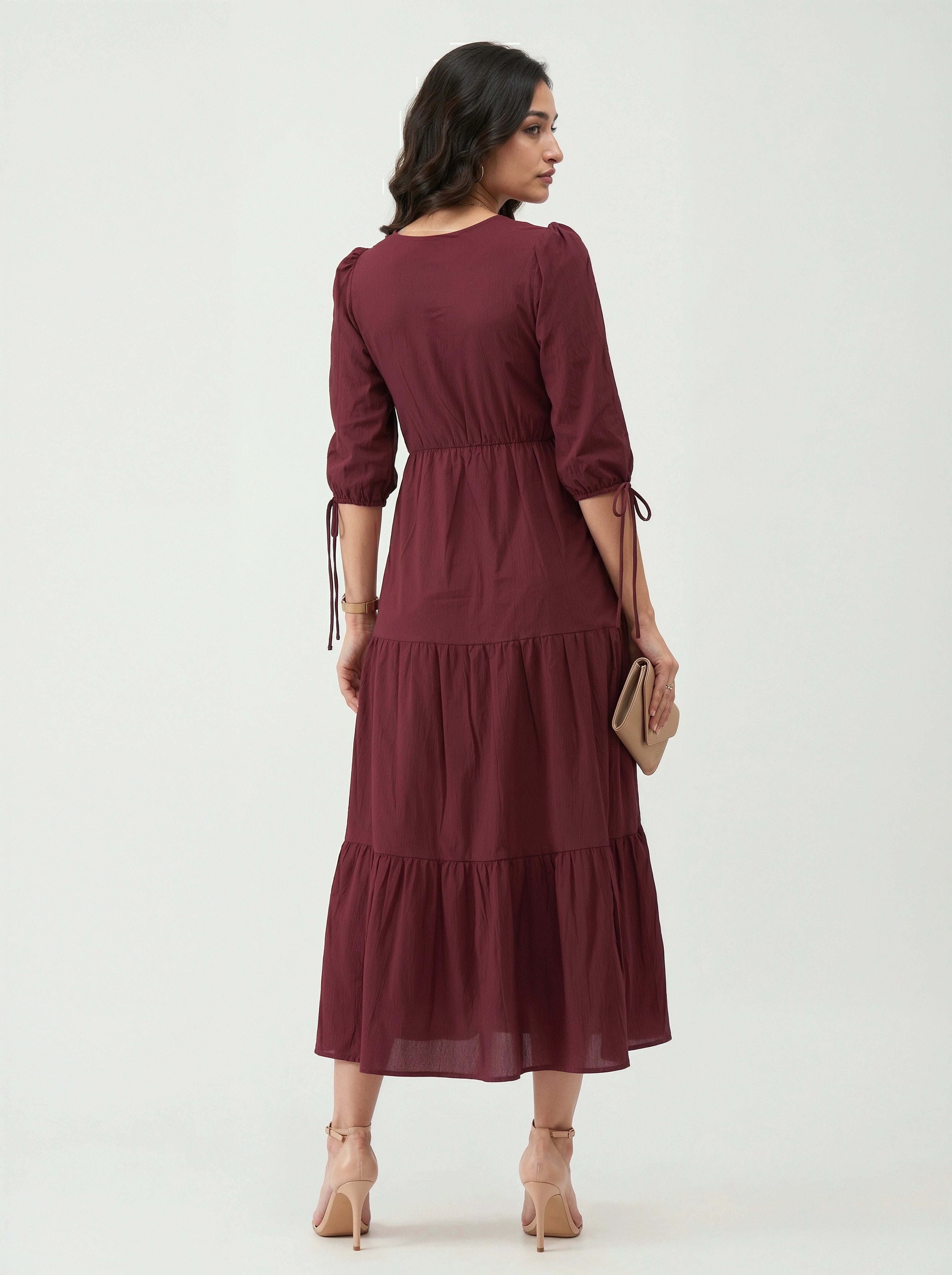 Woman wearing a burgundy dress on a white background