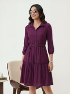 Woman wearing a purple dress with a white background