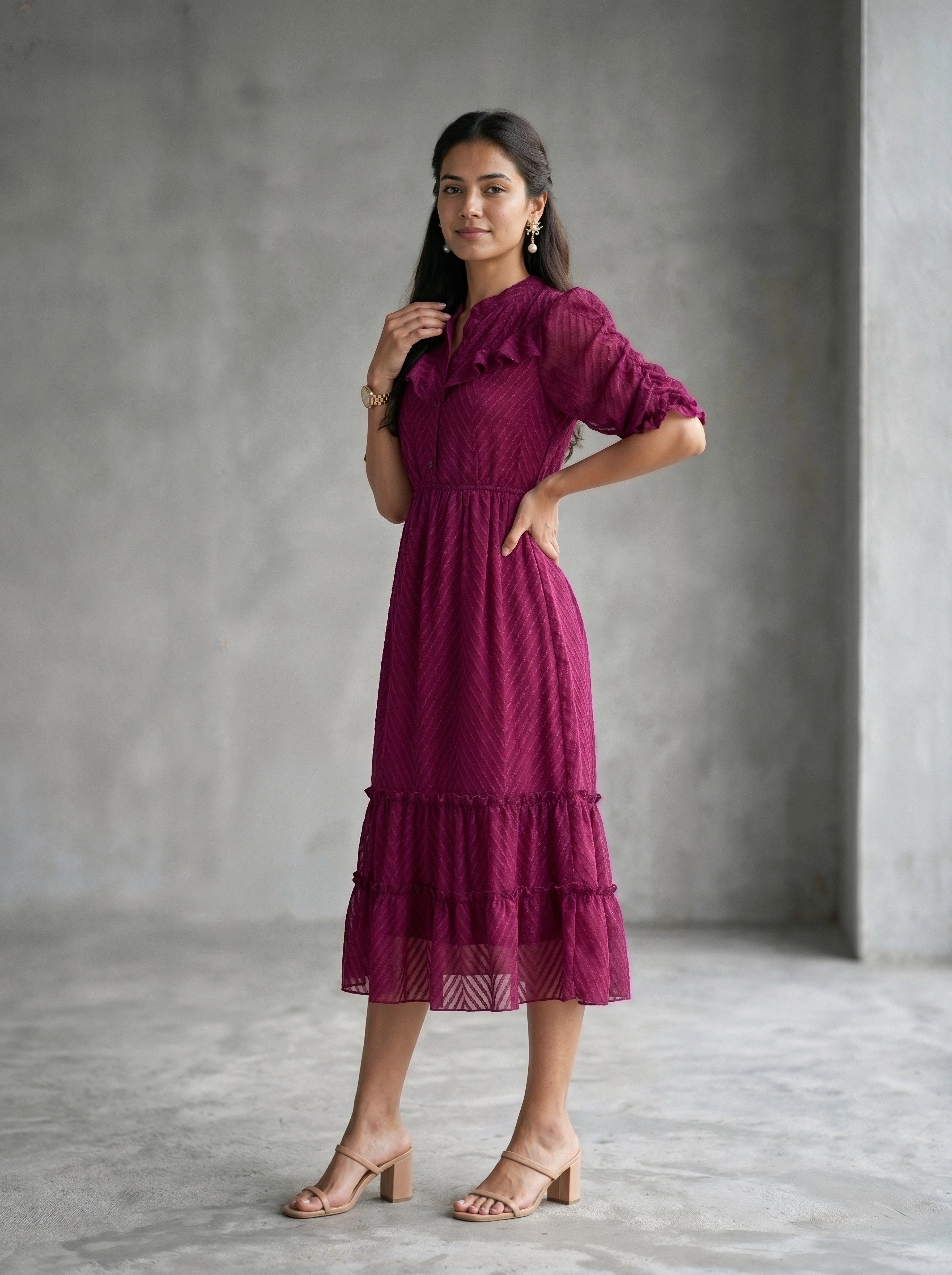 Woman wearing a burgundy dress against a beige background
