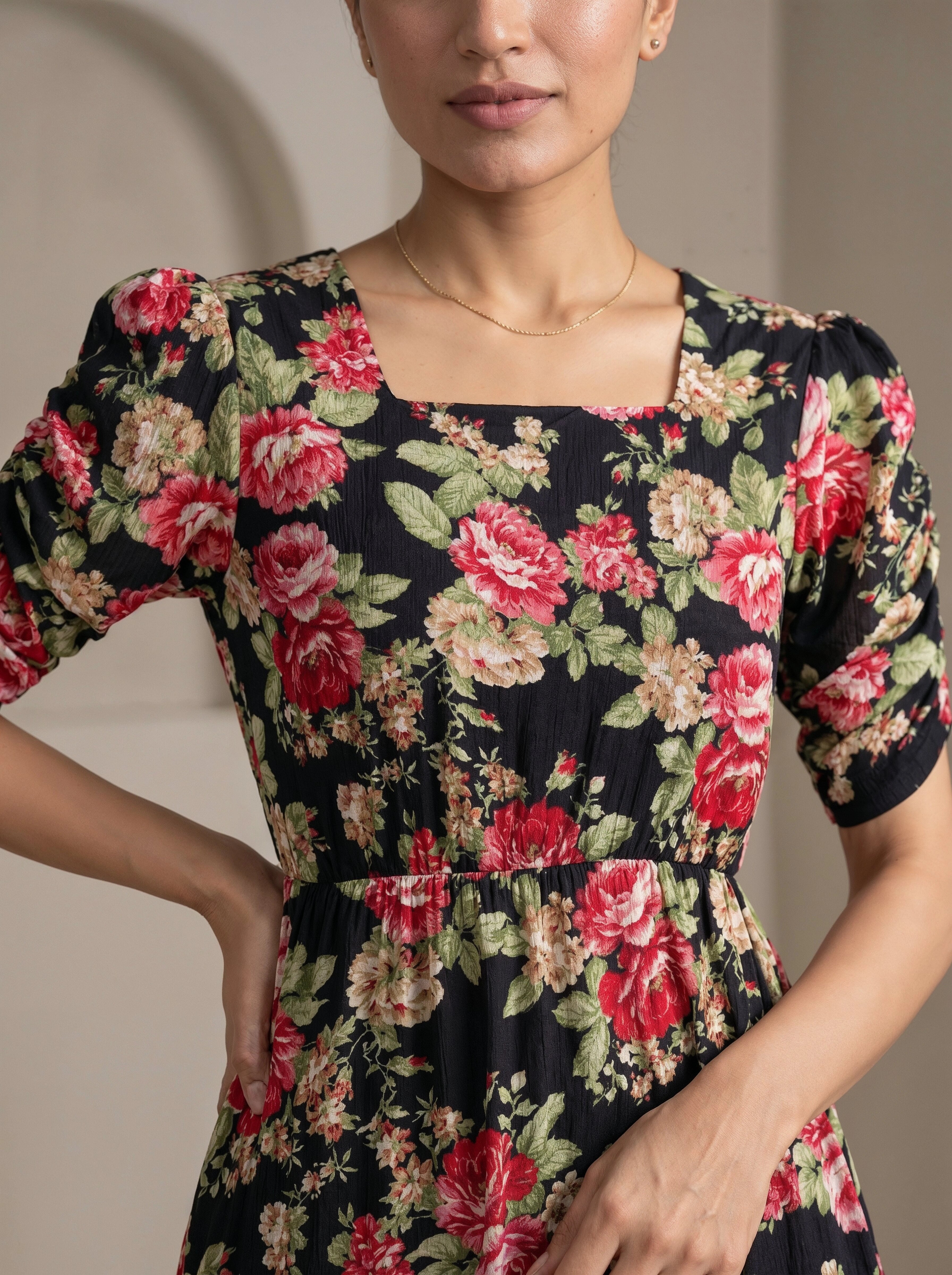 Woman wearing a floral dress with a neutral background