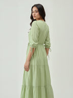 Woman wearing a light green dress with a white background