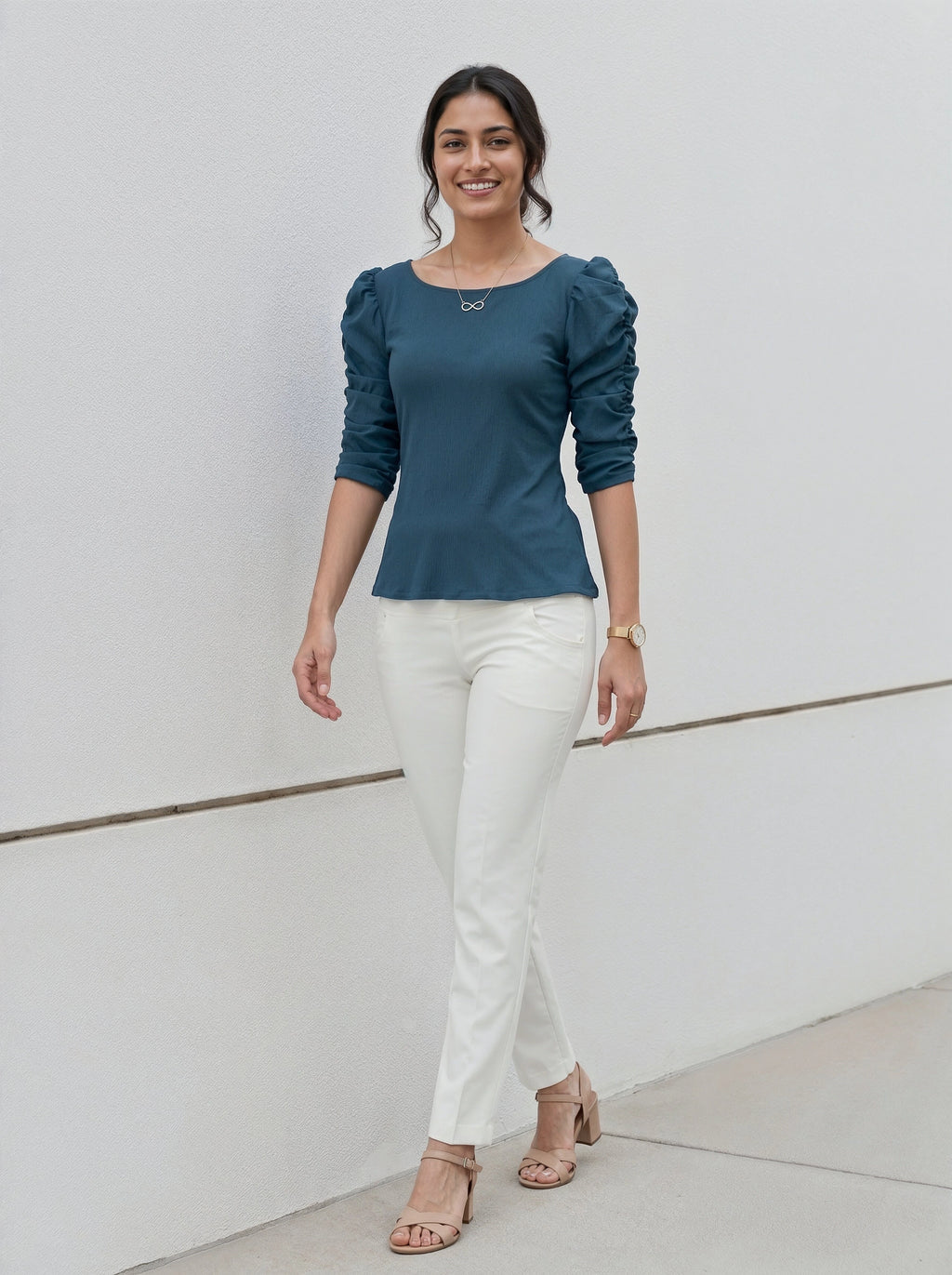 Modern minimalist style outfit with a teal puff-sleeve shirt and crisp white pants.