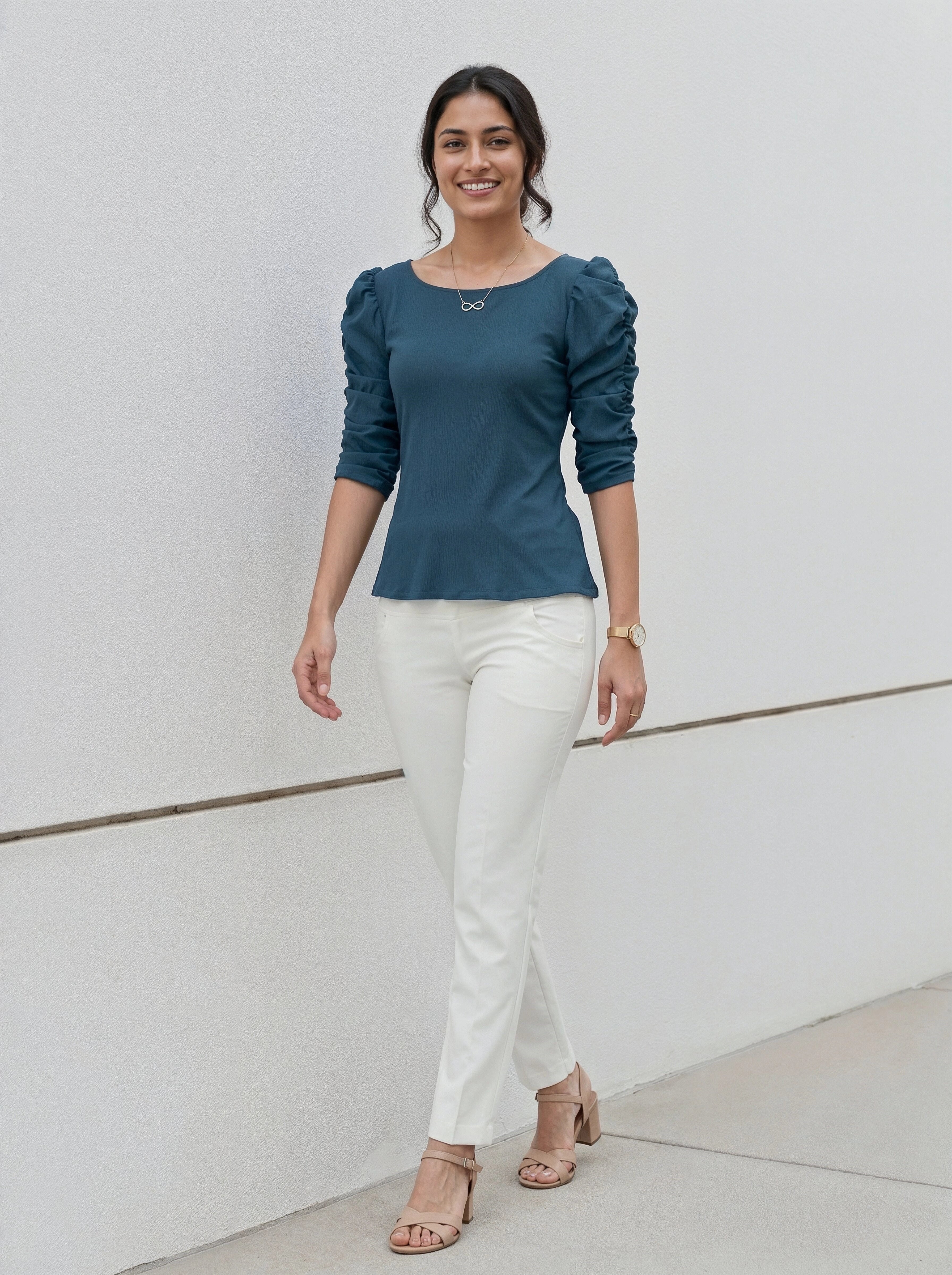 Modern minimalist style outfit with a teal puff-sleeve shirt and crisp white pants.