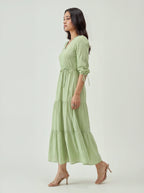 Woman wearing a light green dress on a white background