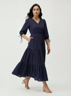 Woman wearing a navy blue dress on a white background