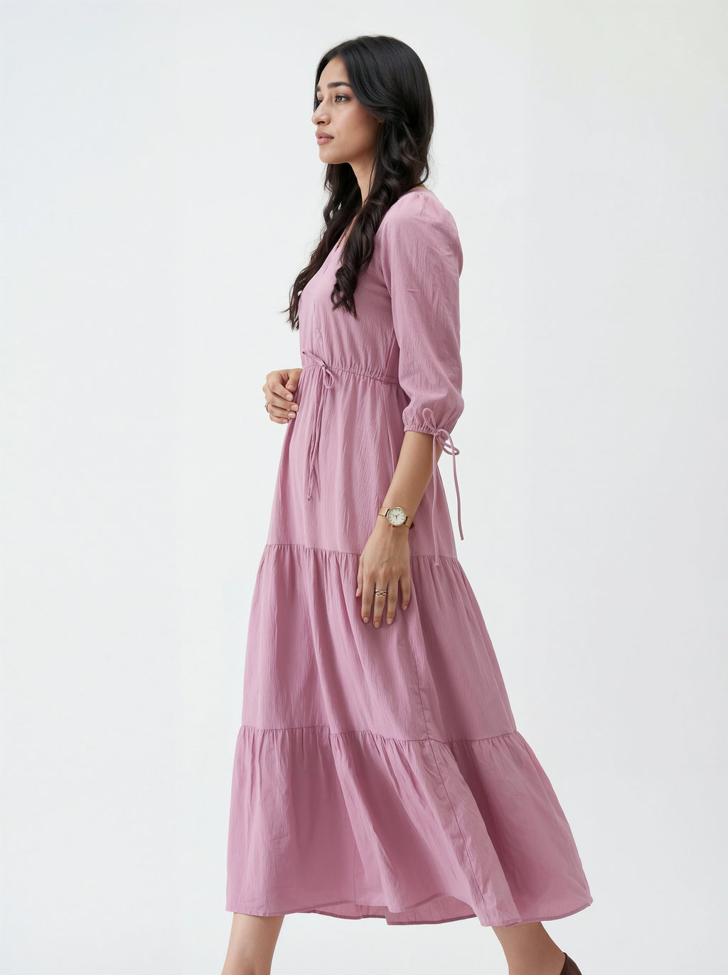 Woman wearing a pink dress against a white background
