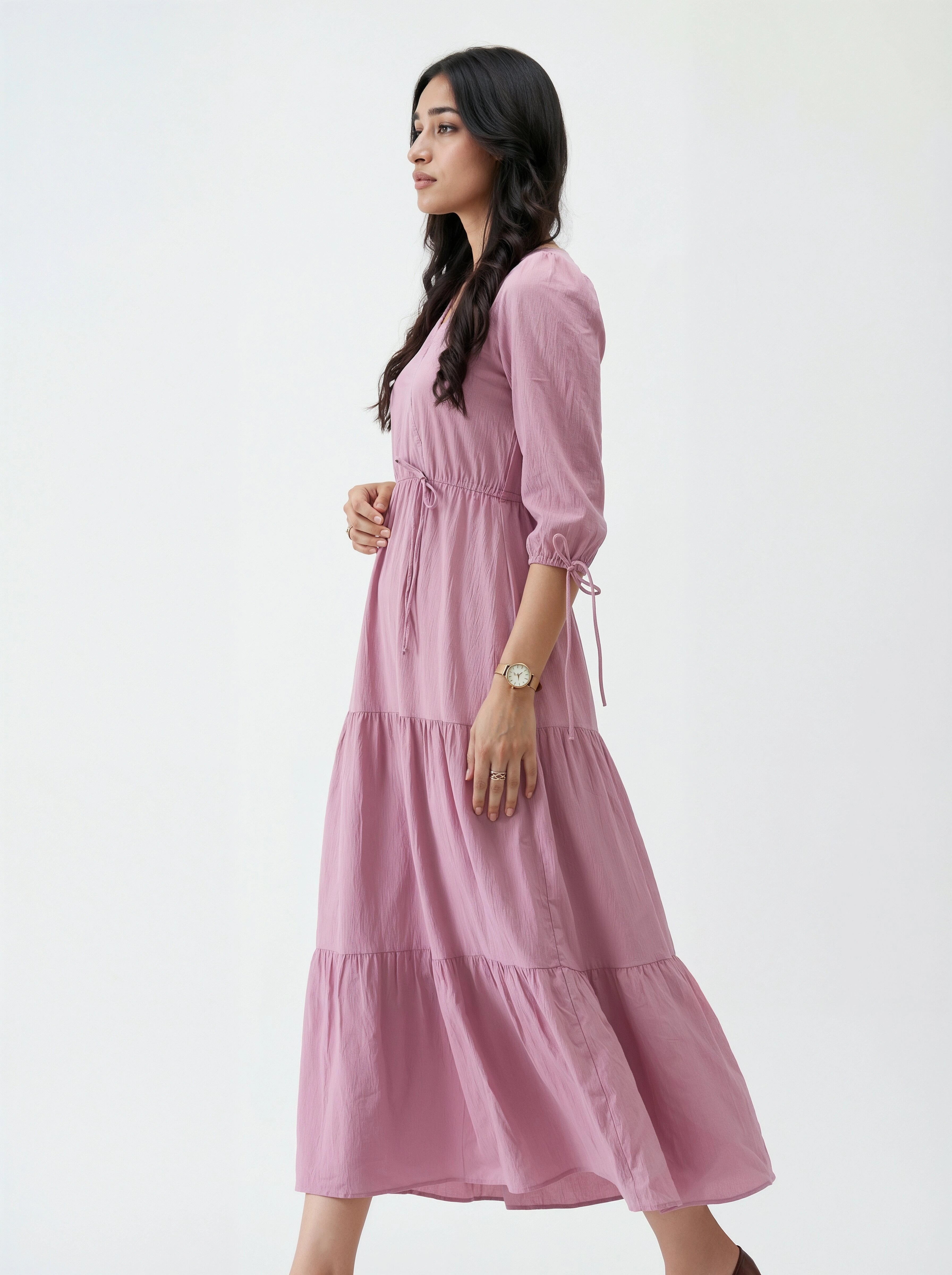 Woman wearing a pink dress against a white background
