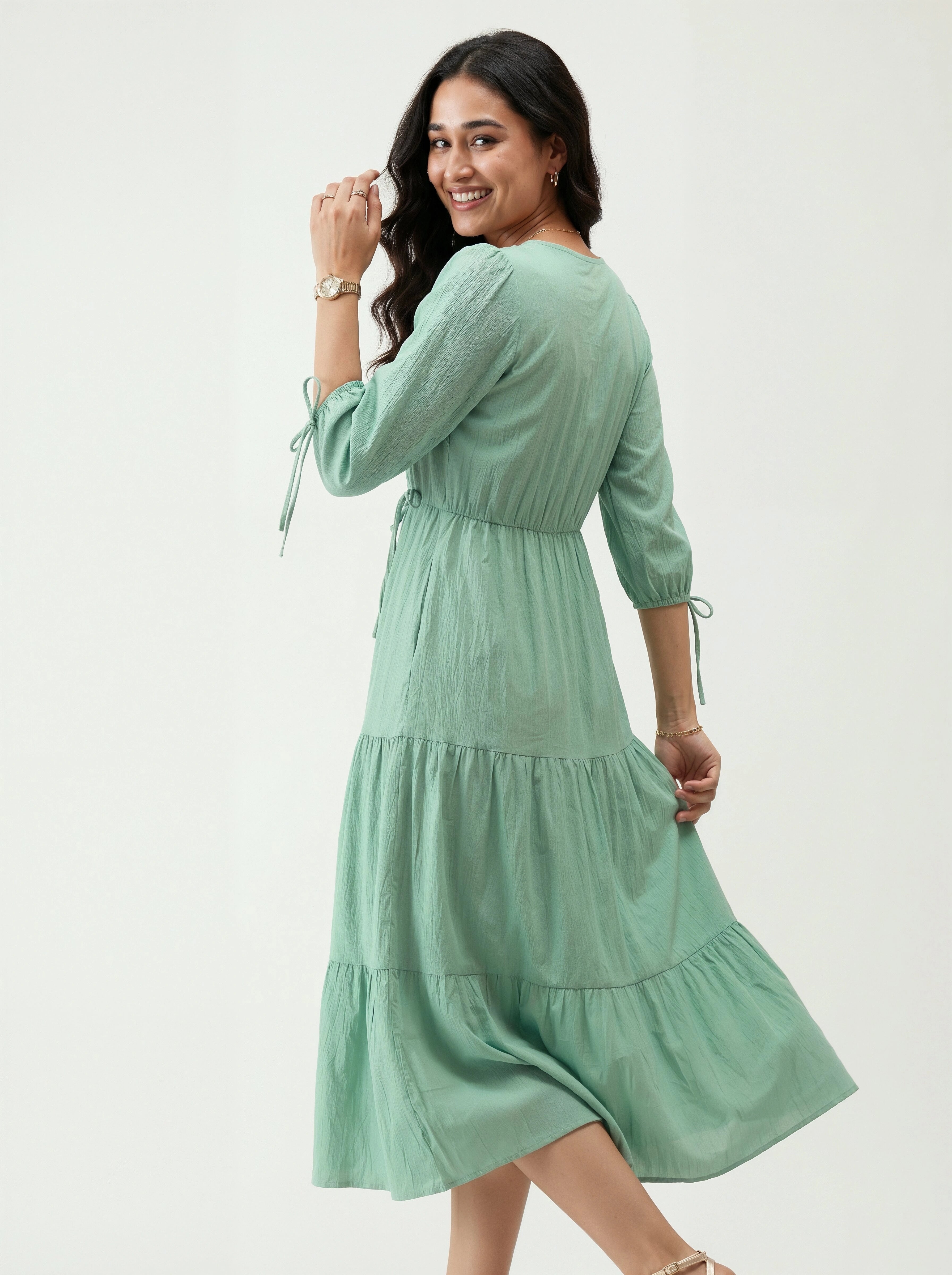 Woman wearing a green dress on a white background