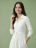 Woman wearing a white dress against a green background